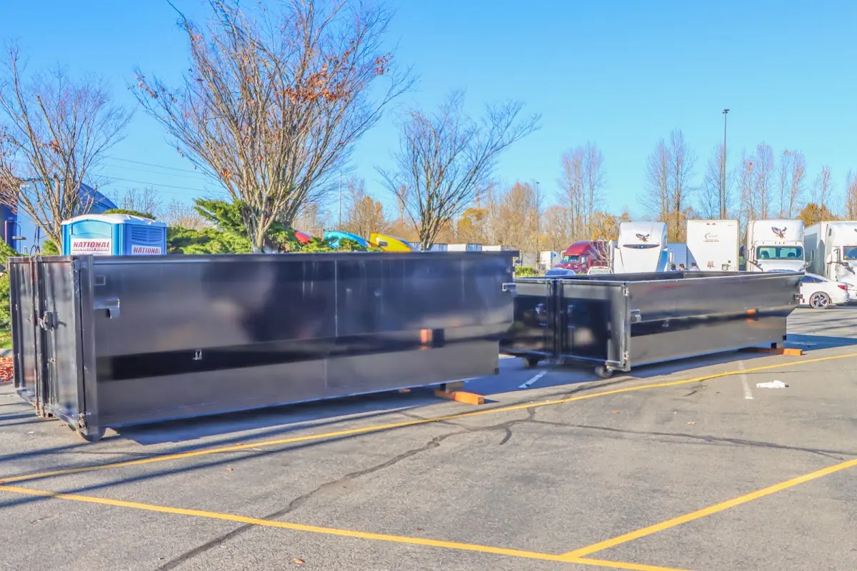 Professional dumpster rental service with roll-off container on residential driveway in Cottonwood